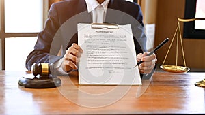 Professional female lawyer or attorney showing a legal contract agreement document