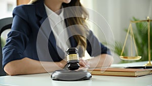 A professional female lawyer or business legal consultant sits at her office desk