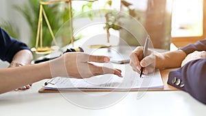 A professional female lawyer meets with her client in private to consult to sign the contract