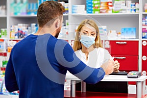 Professional female pharmacist helping male customer choosing prescription drugs