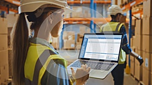 Professional Female Worker Wearing Hard Hat Holds Laptop Computer with Screen Showing Inventory Ch