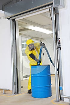 Professional filling large barrel with chemicals