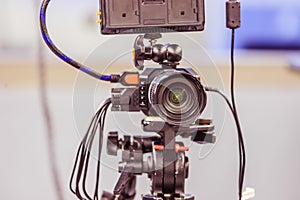 Professional film camera on a tripod in broadcasting studio