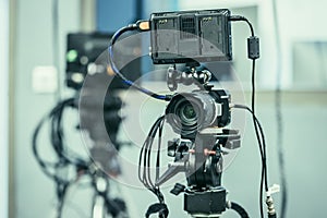 Professional film camera on a tripod in broadcasting studio