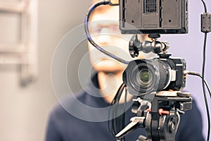 Professional film camera on a tripod in broadcasting studio