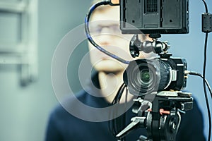 Professional film camera on a tripod in broadcasting studio