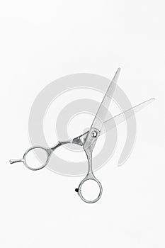 Professional flying scissors for haircuts on white background. Professional tool for hairdressers scissors