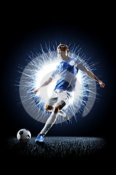 Professional football soccer player in action on black