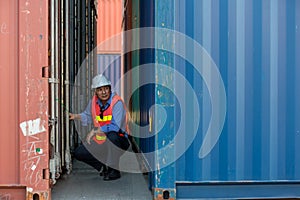 Professional foreman work at Container cargo site check up  goods in container. Workers are opening containers for inspection and