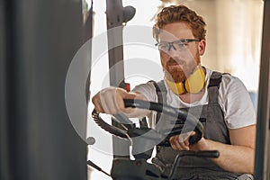 Professional forklift driver in working in wood warehouse and loading wooden board