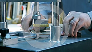 Professional framer hand holding frame angle, working on machine