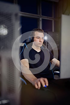 Professional gamer in his expensive studio young man having live stream playing online video game