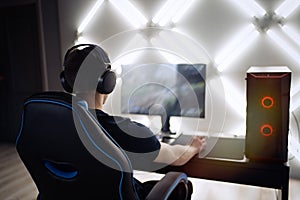 Professional gamer in his expensive studio young man having live stream playing online video game