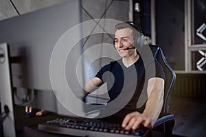 Professional gamer in his expensive studio young man having live stream playing online video game