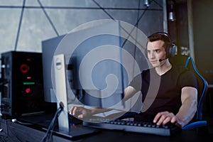Professional gamer in his expensive studio young man having live stream playing online video game