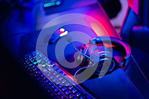 Professional gamers room with headphones microphone for cyber esports and video games on neon background of gaming