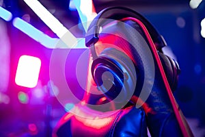 Professional gamers room with headphones microphone for cyber esports and video games on neon background of gaming photo