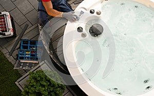 Professional Garden SPA Worker Servicing Modern Hot Tub photo