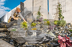 Professional Gardener Finishing Beautiful Rockery Garden