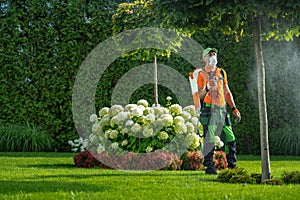 Professional Gardener in His 40s Insecticide Garden Plants
