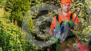 Professional Gardener Operating a Hedge Trimmer