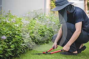 Professional Gardener Trimming Lawn In The Garden