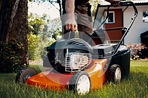 Professional gardener turning on the lawn mower