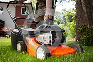 Professional gardener turning on the lawn mower