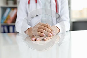 Professional general practitioner or cardiologist sits at table