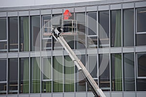 Professional glazier mounting window on building