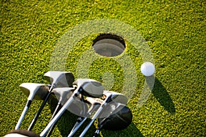 Professional golf equipment on a beautiful, neat lawn, some balls and two golf clubs, sport concept