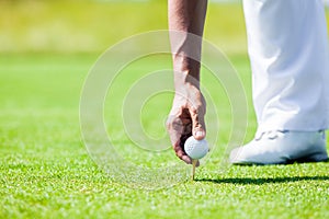 Hand of Professional Golf Player teach how to Teed Up Golf Ball