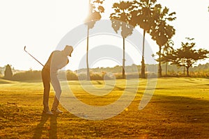 Professional Golfer asian man swing and hitting golf ball practice at golf driving range and fairway in sunny morning day on club