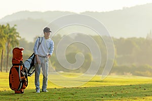 Professional Golfer asian man walking in fairway with bag golf with club.  Hobby in holiday and vacation with friends.