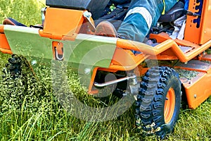 Professional grass cutting on lawns with a mini tractor lawn mower