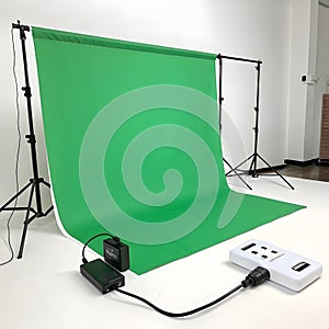 Professional green screen studio setup with lighting and remote control