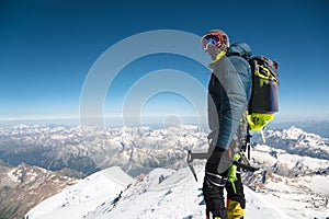 Professional guide - climber on the snow-covered summit of Elbrus sleeping volcano