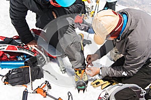 A professional guide helps you set up and dress alpinist crampons