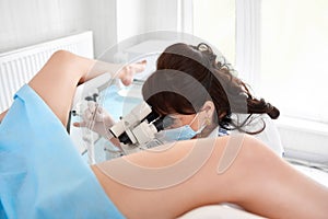 Professional gynecologist examining her patient