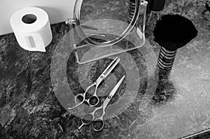 Professional hair cutting scissors, hair brush, paper collars and a mirror in a hairdressing salon