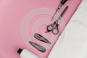 Professional hair dresser tools with copy space. Hair stylist equipment set on pink background.