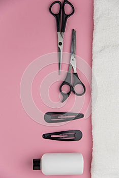 Professional hair dresser tools with copy space. Hair stylist equipment set on pink background.