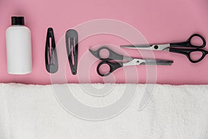 Professional hair dresser tools with copy space. Hair stylist equipment set on pink background.