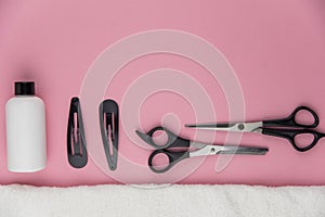 Professional hair dresser tools with copy space. Hair stylist equipment set on pink background.