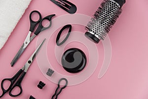 Professional hair dresser tools with copy space. Hair stylist equipment set on pink background.