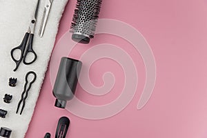 Professional hair dresser tools with copy space. Hair stylist equipment set on pink background.