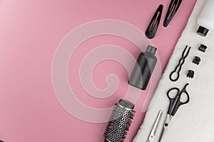 Professional hair dresser tools with copy space. Hair stylist equipment set on pink background.