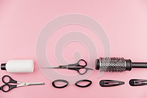 Professional hair dresser tools with copy space. Hair stylist equipment set on pink background.