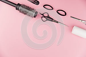 Professional hair dresser tools with copy space. Hair stylist equipment set on pink background.