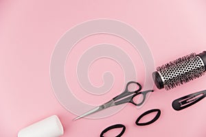 Professional hair dresser tools with copy space. Hair stylist equipment set on pink background.